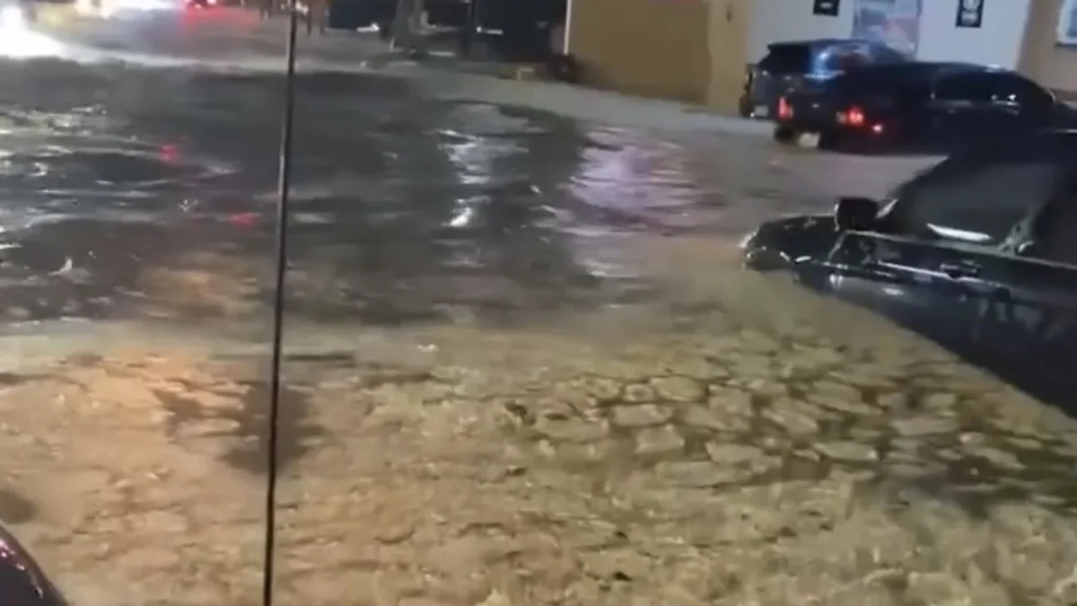 Automóviles circulan entre agua y granizo sobre la avenida Insurgentes de Ciudad Juárez